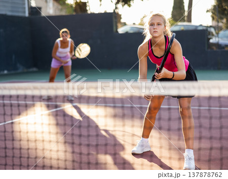 Caucasian woman wearing in pink t-shirt and skirt playing tennis match during training Caucasian woman wearing in pink t-shirt and skirt playing tennis match during training 137878762