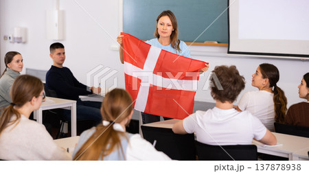 Female professor shows students flag of Denmark Female professor shows students flag of Denmark 137878938