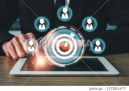Businessman interacting with digital tablet, showcasing target and network icons for CRM and marketing strategy. Businessman interacting with digital tablet, showcasing target and network icons for CRM and marketing strategy. 137881477