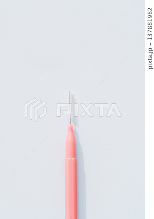 Interdental brush close up on light blue background, minimal oral hygiene concept with copy space 137881982