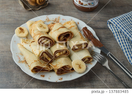 Sweet Crepes with Chocolate Spread and Banana Sweet Crepes with Chocolate Spread and Banana 137883485
