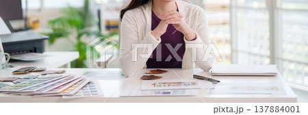 Asian adult woman designer planning creative project interior architecture colors swatches layouts bright modern office professional workspace desk Asian adult woman designer planning creative project interior architecture colors swatches layouts bright modern office professional workspace desk 137884001