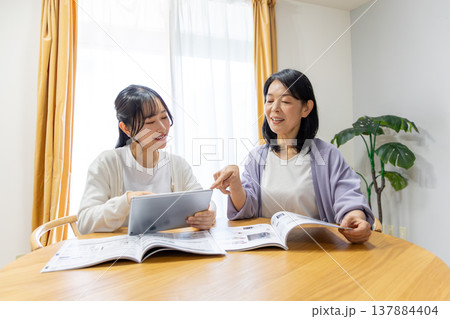 カタログを見る母娘 カタログを見る母娘 137884404
