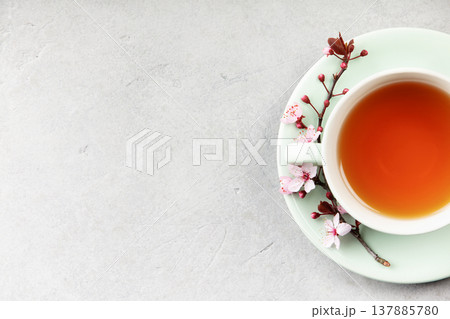 Cup of Tea with Spring Blossom on Mint Saucer Flat Lay 137885780