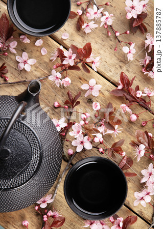 Japanese Teapot and Cups with Cherry Blossoms on Wooden Table Japanese Teapot and Cups with Cherry Blossoms on Wooden Table 137885787