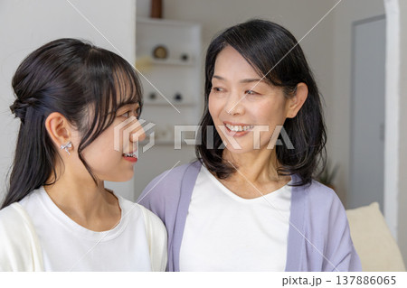 リビングで会話をする仲の良い母娘 137886065