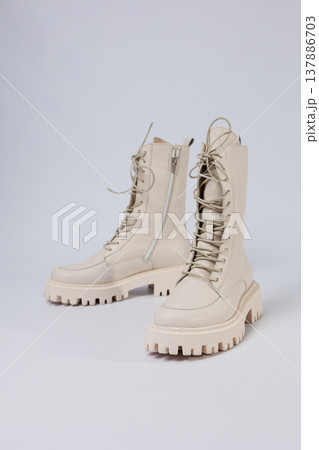 Women's white winter boots with fur with thick soles and laces. Advertising of the new collection of women's shoes 2022 Women's white winter boots with fur with thick soles and laces. Advertising of the new collection of women's shoes 2022 137886703