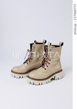 Beautiful beige shoes with genuine leather on an isolated white studio background. Fashionable classic women's boots. Stylish elegant leather shoes. Beautiful beige shoes with genuine leather on an isolated white studio background. Fashionable classic women's boots. Stylish elegant leather shoes. 137886737