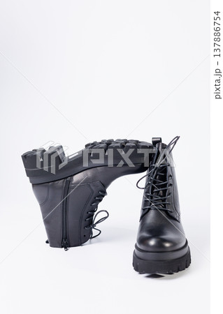 Women's black leather boots on a white background. Shoes and options for its layout. Autumn shoes. Boots. Autumn boots. Shoes close up Women's black leather boots on a white background. Shoes and options for its layout. Autumn shoes. Boots. Autumn boots. Shoes close up 137886754