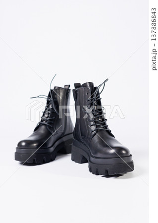 Women's black leather boots on a white background. Shoes and options for its layout. Autumn shoes. Boots. Autumn boots. Shoes close up 137886843