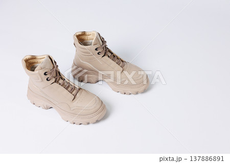 Beautiful shoes on an isolated white studio background. Fashionable beige women's shoe. Elegant stylish footwear. Beautiful shoes on an isolated white studio background. Fashionable beige women's shoe. Elegant stylish footwear. 137886891