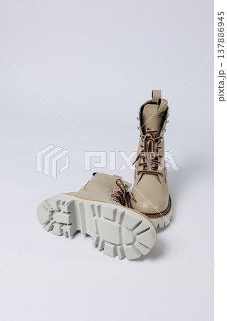 Beautiful beige shoes with genuine leather on an isolated white studio background. Fashionable classic women's boots. Stylish elegant leather shoes. Beautiful beige shoes with genuine leather on an isolated white studio background. Fashionable classic women's boots. Stylish elegant leather shoes. 137886945