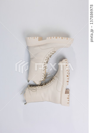 Women's white winter boots with fur with thick soles and laces. Advertising of the new collection of women's shoes 2022 Women's white winter boots with fur with thick soles and laces. Advertising of the new collection of women's shoes 2022 137886978