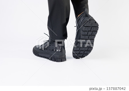 Men's black boots made of genuine leather, men's footwear on a white background. Winter men's shoes 2022 Men's black boots made of genuine leather, men's footwear on a white background. Winter men's shoes 2022 137887042