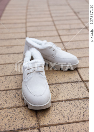 women's white leather shoes stand on a tile. Collection of autumn women's shoes 137887116