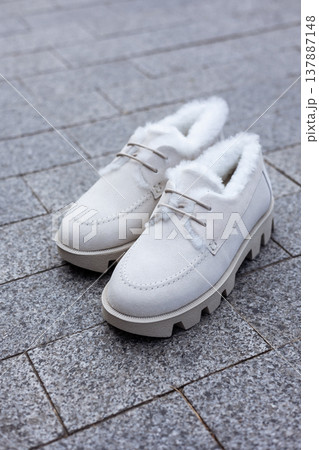 women's white leather shoes stand on a tile. Collection of autumn women's shoes 137887148
