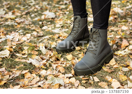 New collection of women's spring shoes. Slender female legs close-up in genuine leather boots. 137887150