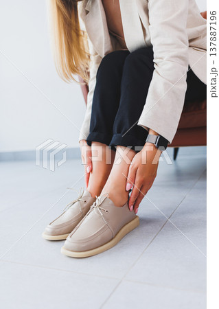 Beige women's leather shoes close-up on female legs. New collection of women's summer leather shoes. 137887196