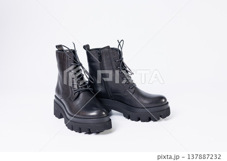 Women's black leather boots on a white background. Shoes and options for its layout. Autumn shoes. Boots. Autumn boots. Shoes close up 137887232