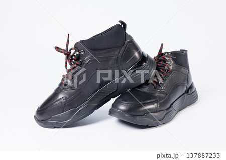 Leather black short men's autumn sneakers on a white background. Sneakers winter collection 2022. Leather black short men's autumn sneakers on a white background. Sneakers winter collection 2022. 137887233