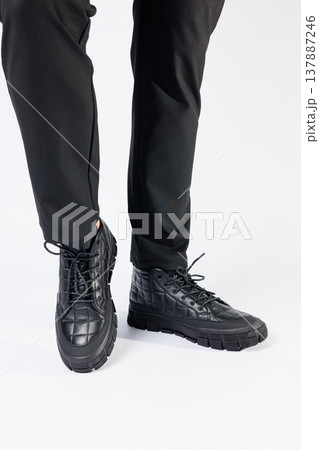 Men's black boots made of genuine leather, men's footwear on a white background. Winter men's shoes 2022 Men's black boots made of genuine leather, men's footwear on a white background. Winter men's shoes 2022 137887246
