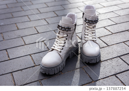 women's white leather shoes stand on a tile. Collection of autumn women's shoes 137887254