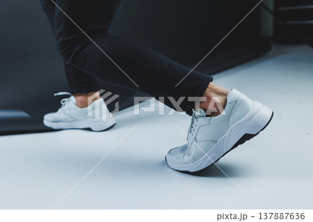 Men's casual white shoes made of genuine leather, men on shoes in white sneakers. High quality photo 137887636