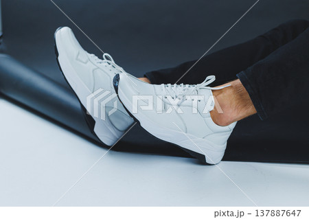 Men's casual white shoes made of genuine leather, men on shoes in white sneakers. High quality photo 137887647