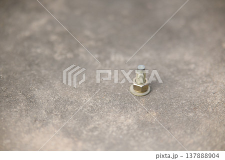 screw fastening nut on cement floor in construction working screw fastening nut on cement floor in construction working 137888904
