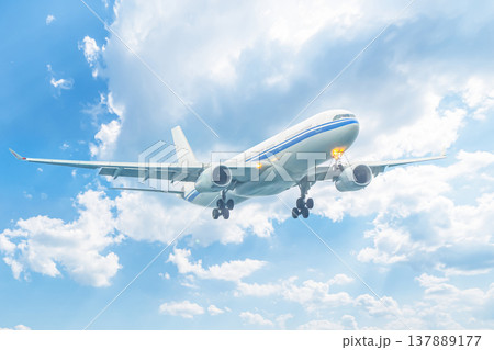 A plane flying through the sky against a background of clouds. Flights and air travel, sale of Ruhr and airline tickets, and tourism. High quality photo A plane flying through the sky against a background of clouds. Flights and air travel, sale of Ruhr and airline tickets, and tourism. High quality photo 137889177