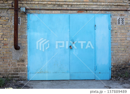 old metal door to the car garage old metal door to the car garage 137889489