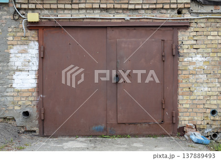 old metal door to the car garage old metal door to the car garage 137889493