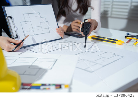 Person's engineer Hand Drawing Plan On Blue Print with architect equipment. Person's engineer Hand Drawing Plan On Blue Print with architect equipment. 137890425