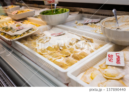 Genoa, liguria, italy. May 18, 2024. Fresh ravioli, pansoti and assorted handmade pastas displayed at a genoa market stall, ready for purchase and cooking Genoa, liguria, italy. May 18, 2024. Fresh ravioli, pansoti and assorted handmade pastas displayed at a genoa market stall, ready for purchase and cooking 137890440