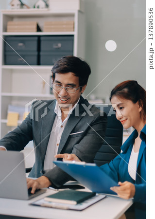 Professionals listening to a discussion in an office 137890536