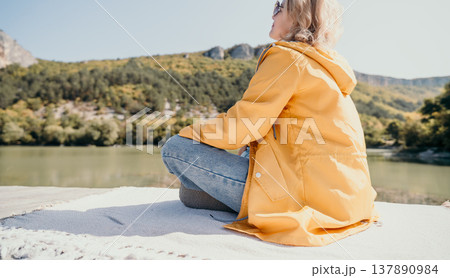 Woman in Yellow Jacket Contemplating Nature Woman in Yellow Jacket Contemplating Nature 137890984