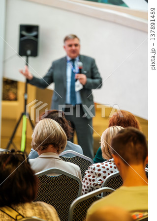 Business speaker addressing seated audience at conference or seminar in meeting room Business speaker addressing seated audience at conference or seminar in meeting room 137891489