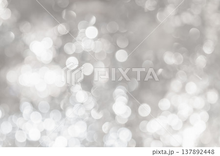 Cool toned bokeh lights with soft blur and scattered highlights forming an abstract lighting pattern that creates a calm winter mood for seasonal design use. Cool toned bokeh lights with soft blur and scattered highlights forming an abstract lighting pattern that creates a calm winter mood for seasonal design use. 137892448