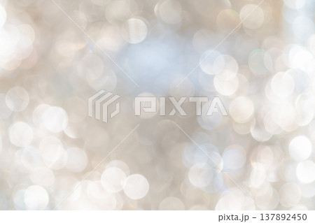 Cool toned bokeh lights with soft blur and scattered highlights forming an abstract lighting pattern that creates a calm winter mood for seasonal design use. 137892450