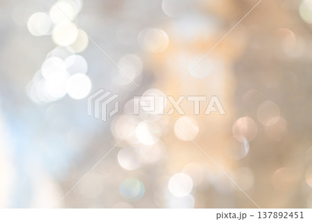 Cool toned bokeh lights with soft blur and scattered highlights forming an abstract lighting pattern that creates a calm winter mood for seasonal design use. 137892451