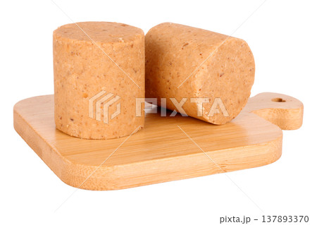 Two pacocas, a traditional Brazilian sweet made with peanuts, on an isolated wooden base against a white background 137893370