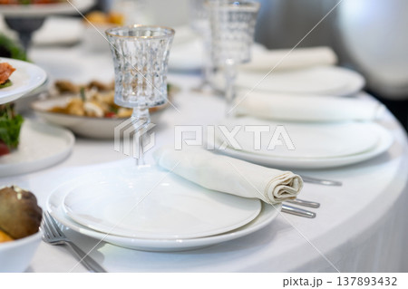 Elegant Restaurant Table Setting with Glasses and Plates. Elegant Restaurant Table Setting with Glasses and Plates. 137893432