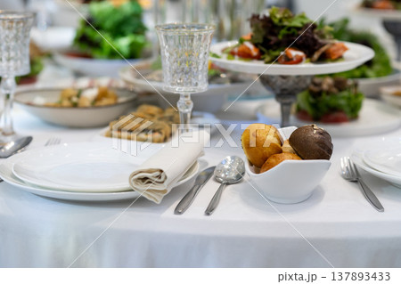 Elegant Restaurant Table Setting with Glasses and Plates. 137893433