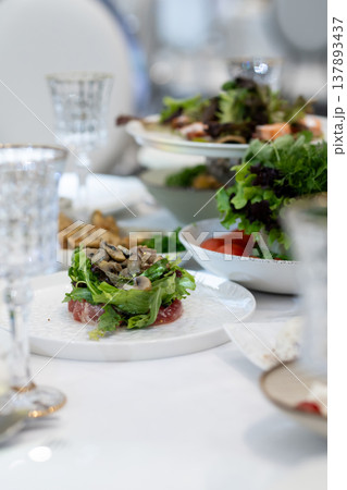 Elegant Restaurant Table Setting with Glasses and Plates. Vertical. Elegant Restaurant Table Setting with Glasses and Plates. Vertical. 137893437