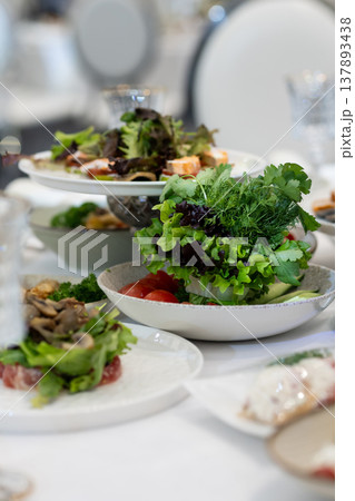 Elegant Restaurant Table Setting with Glasses and Plates. Salad Elegant Restaurant Table Setting with Glasses and Plates. Salad 137893438