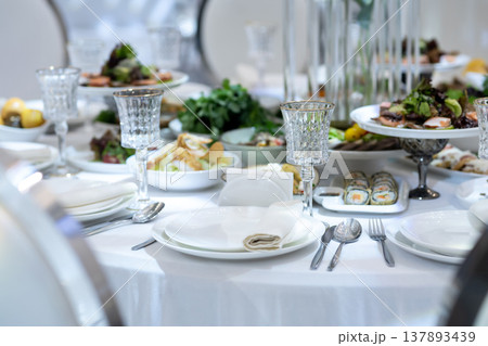 Elegant Restaurant Table Setting with Glasses and Plates. Elegant Restaurant Table Setting with Glasses and Plates. 137893439