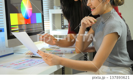 Cropped shot two graphic design desk sharing idea and creative with color in creative studio 137893621