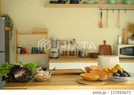 Fresh healthy food ingredients on kitchen counter, vegetables and fruits prepared for nutritious home cooking and balanced diet 137893675