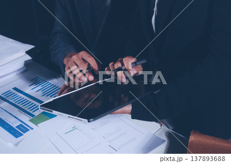 Professional photo of a person's hands reviewing a contract or legal document on a desk, for concepts of business, finance, and legal affairs Professional photo of a person's hands reviewing a contract or legal document on a desk, for concepts of business, finance, and legal affairs 137893688