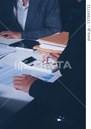 Professional photo of a person's hands reviewing a contract or legal document on a desk, for concepts of business, finance, and legal affairs Professional photo of a person's hands reviewing a contract or legal document on a desk, for concepts of business, finance, and legal affairs 137893711